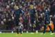Manchester City's David Silva, left, reacts as he stands alongside teammates after Liverpool's third goal during the English Premier League soccer match between Liverpool and Manchester City at Anfield Stadium, Liverpool, England, Wednesday, March 2, 2016. (AP Photo/Jon Super)