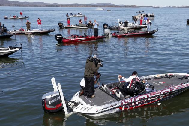 Randall Tharp, Port Saint Joe, Fla., holds up a bass for spectators following him on the second day of the Bassmaster Classic, Saturday, Feb. 22, 2014, in Guntersville, Ala. Tharp was bumped from first to second by 1 ounce by Edwin Evers, Talala, Okla. The field will be cut to the top 25 anglers for the final day of competition. (AP Photo/Hal Yeager)
