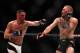 LAS VEGAS, NV - MARCH 05: (L-R) Nate Diaz punches Conor McGregor of Ireland during the UFC 196 event inside MGM Grand Garden Arena on March 5, 2016 in Las Vegas, Nevada. (Photo by Jeff Bottari/Zuffa LLC/Zuffa LLC via Getty Images)