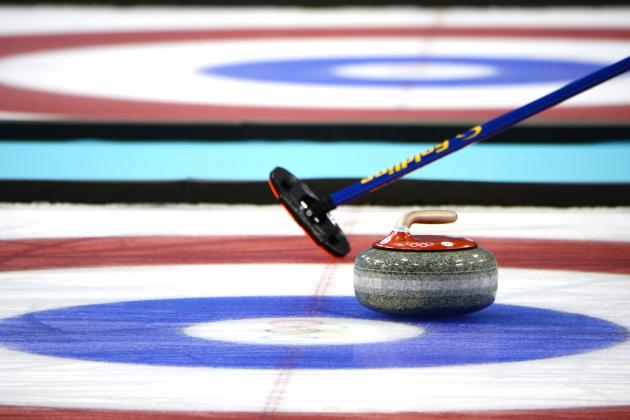 Feb 21, 2014; Sochi, RUSSIA; A detailed view of a stone and sweeper in the curling men's bronze medal match during the Sochi 2014 Olympic Winter Games at Ice Cube Curling Center. Mandatory Credit: James Lang-USA TODAY Sports
