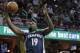 Memphis Grizzlies' P.J. Hairston (19) grabs a rebound ahead of Cleveland Cavaliers' Kevin Love (0) in the first half of an NBA basketball game Monday, March 7, 2016, in Cleveland. (AP Photo/Tony Dejak)