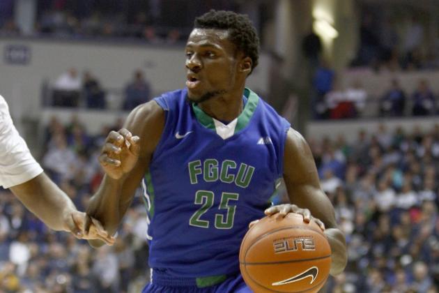 Florida Gulf Coast forward Marc-Eddy Norelia (25) drives against Xavier forward James Farr (2) during an NCAA college basketball game, Sunday, Dec. 28, 2014, in Cincinnati. Xavier won 71-57. (AP Photo/David Kohl)