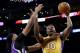 Los Angeles Lakers forward Julius Randle, right, shoots around Sacramento Kings forward Rudy Gay during the second half of an NBA basketball game in Los Angeles, Tuesday, March 15, 2016. (AP Photo/Chris Carlson)