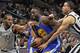 Golden State Warriors forward Draymond Green (23) tangles with San Antonio Spurs' Kawhi Leonard (2) and Kevin Martin during the first half of an NBA basketball game, Saturday, March 19, 2016, in San Antonio. San Antonio won 87-79. (AP Photo/Darren Abate)