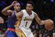 Los Angeles Lakers guard D'Angelo Russell (1) backs into New York Knicks guard Arron Afflalo (4) during the second half of an NBA basketball game in Los Angeles, Sunday, March 13, 2016. The Knicks won 90-87. (AP Photo/Alex Gallardo)