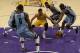 Los Angeles Lakers guard Jordan Clarkson, center, movies the ball defended by Memphis Grizzlies forward Zach Randolph, right, during the second half of an NBA basketball game in Los Angeles, Tuesday, March 22, 2016. The Los Angeles Lakers won 107-100. (AP Photo/Kelvin Kuo)