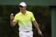 Rory McIlroy, of Northern Ireland, holds up his ball after saving par on the third green during the fourth round of the Masters golf tournament Sunday, April 12, 2015, in Augusta, Ga. (AP Photo/Chris Carlson)
