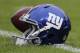 A New York Giants helmet sits on the field before an NFL football game against the Washington Redskins in Landover, Md., Sunday, Nov. 29, 2015. (AP Photo/Mark Tenally)