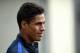 France's defender Raphael Varane arrives for a press conference in Clairefontaine on March 21, 2016 on the first day of their training ahead of the friendly football match against The Netherlands to be held on March 25. / AFP / FRANCK FIFE (Photo credit should read FRANCK FIFE/AFP/Getty Images)