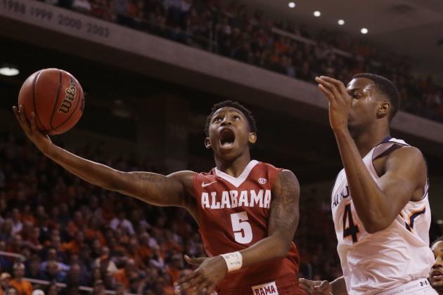Alabama guard Justin Coleman (5) shoots as Auburn center Trayvon Reed (4) guards during the first half during an NCAA college basketball game Tuesday, Feb. 17, 2015, in Auburn, Ala. (AP Photo/Brynn Anderson)