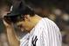 New York Yankees starting pitcher Nathan Eovaldi touches his cap as he enters the dugout in the fifth inning of a baseball game against the Houston Astros at Yankee Stadium in New York, Monday, Aug. 24, 2015. (AP Photo/Kathy Willens)
