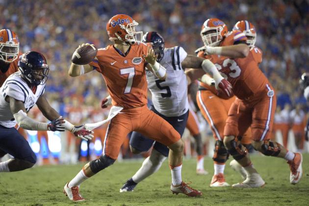 Florida quarterback Will Grier (7) throws a pass between Mississippi linebacker C.J. Johnson, left, and defensive tackle Robert Nkemdiche (5) during the first half of an NCAA college football game Saturday, Oct. 3, 2015, in Gainesville, Fla. Florida won 38-10. (AP Photo/Phelan M. Ebenhack)