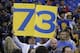 A Golden State Warriors fan holds up a 73 sign before an NBA basketball game between the Warriors and the Memphis Grizzlies in Oakland, Calif., Wednesday, April 13, 2016. The Warriors had 72 wins heading into their final regular-season game, the same number of wins as the 1995-1996 Chicago Bulls. (AP Photo/Marcio Jose Sanchez)