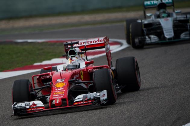Ferrari's German driver Sebastian Vettel takes a corner in front of Mercedes AMG Petronas F1 Team's German driver Nico Rosberg during the second practice session at the Formula One Chinese Grand Prix in Shanghai on April 15, 2016. / AFP / JOHANNES EISELE (Photo credit should read JOHANNES EISELE/AFP/Getty Images)