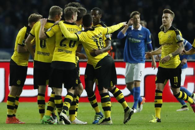 Dortmund's midfielder Gonzalo Castro (hidden) celebrates scoring the opening goal with his team-mates during the German Cup (DFB Pokal) semi-final football match Hertha Berlin v Borussia Dortmund at the Olympic stadium in Berlin on April 20, 2016. / AFP / ODD ANDERSEN / RESTRICTIONS: ACCORDING TO DFB RULES IMAGE SEQUENCES TO SIMULATE VIDEO IS NOT ALLOWED DURING MATCH TIME. MOBILE (MMS) USE IS NOT ALLOWED DURING AND FOR FURTHER TWO HOURS AFTER THE MATCH. == RESTRICTED TO EDITORIAL USE == FOR MORE INFORMATION CONTACT DFB DIRECTLY AT +49 69 67880

 /         (Photo credit should read ODD ANDERSEN/AFP/Getty Images)