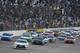 Denny Hamlin (20) and Joey Logano (22) lead the field at the start of the Xfinity series NASCAR auto race at Richmond International Raceway in Richmond, Va., Friday, April 24, 2015. (AP Photo/Steve Helber)