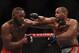 LAS VEGAS, NV - JANUARY 03: Jon Jones (L) and Daniel Cormier (R) exchange punches in their UFC light heavyweight championship bout during the UFC 182 event at the MGM Grand Garden Arena on January 3, 2015 in Las Vegas, Nevada. (Photo by Jeff Bottari/Zuffa LLC/Zuffa LLC via Getty Images)