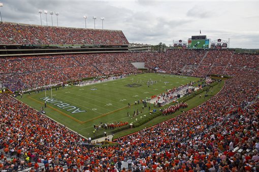 FILE - In this Sept. 27, 2014, file photo, fans watch an NCAA college football game between Auburn and Louisiana Tech at Jordan-Hare Stadium in Auburn, Ala. Auburn will have a new scoreboard at Jordan-Hare Stadium in place for next season. University trustees approved the estimated $13.9 million project on Friday, Feb. 6, 2015,  for what athletic director Jay Jacobs says will be the largest video board in college football. (AP Photo/Brynn Anderson, File)