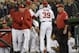 Washington Nationals' Bryce Harper, center, is restrained by bench coach Chris Speier, left, pitching coach Mike Maddux, second from left, and hitting coach Rick Schu (39) after Harper was ejected in the dugout during the ninth inning of an interleague baseball game against the Detroit Tigers, Monday, May 9, 2016, in Washington. The Nationals won 5-4. (AP Photo/Nick Wass)