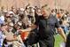 FILE - In this Aug. 15, 2014, file photo, former NFL coach and current ESPN analyst Jon Gruden greets fans at the Cleveland Browns football training camp in Berea, Ohio. The future of youth sports makes Jon Gruden cringe. The Super Bowl-winning coach and ESPN football analyst is part of a program aimed at repairing fields and buying uniforms and equipment. More needs to be done, Gruden says, particularly in low-income areas. (AP Photo/Mark Duncan, File)