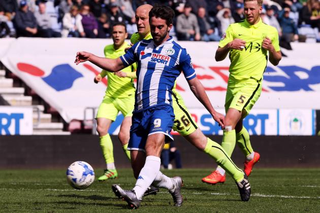 WIGAN, ENGLAND - APRIL 23:  Will Grigg of Wigan Athletic (C) shoots to score during the Sky Bet League One match between Wigan Athletic and Southend United at DW Stadium on April 23, 2016 in Wigan, England.  (Photo by Nigel Roddis/Getty Images)