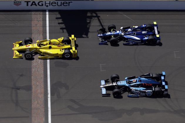 Helio Castroneves, of Brazil, leads Carlos Munoz, of Colombia, (26) and Josef Newgarden across the start/finish line on the main straightway during a practice session for the Indianapolis 500 auto race at Indianapolis Motor Speedway in Indianapolis, Monday, May 23, 2016. (AP Photo/Michael Conroy)