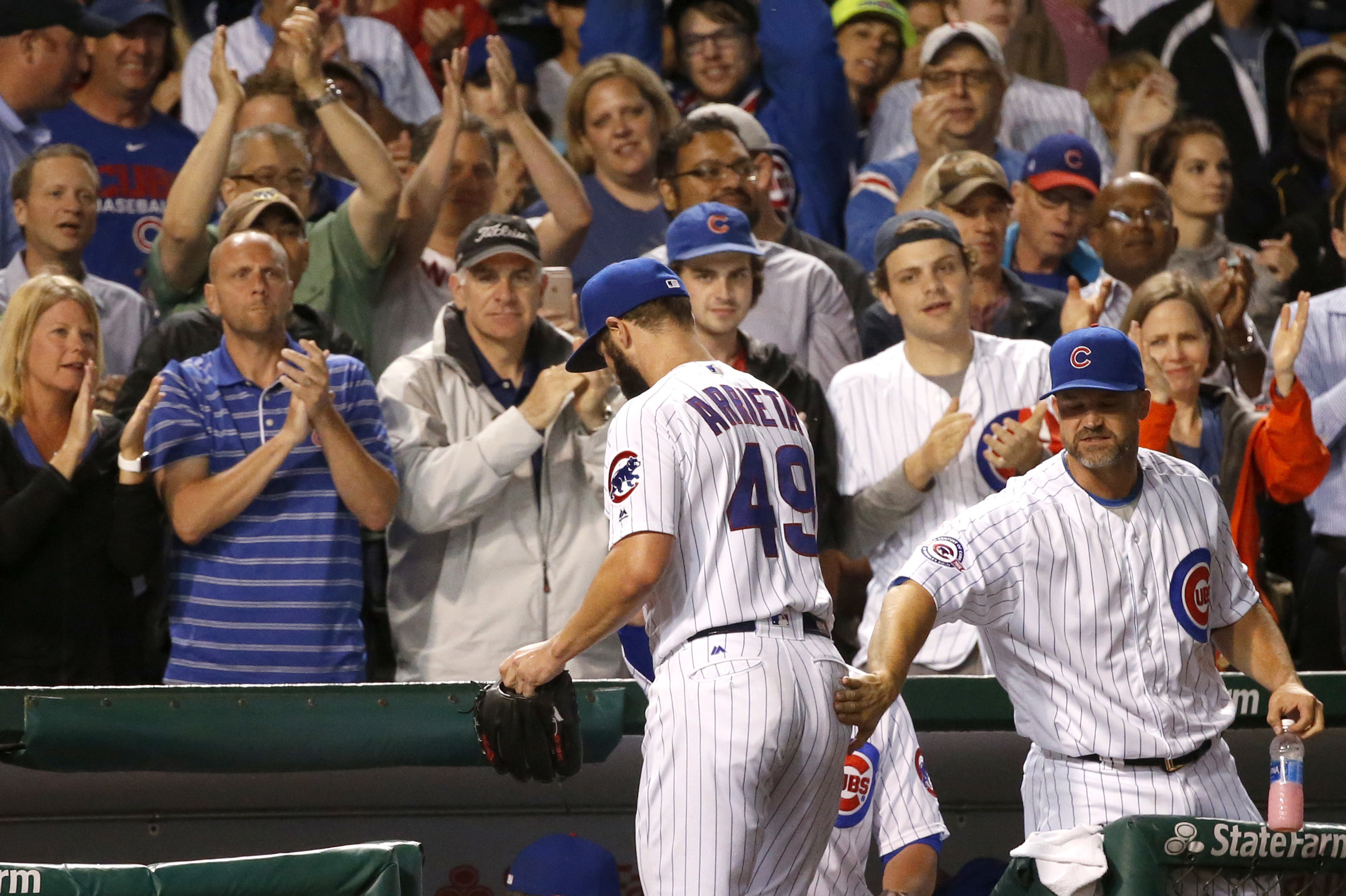 Chicago Cubs pitcher Jake Arrieta, left, receives a Championship Ring  during a ring ceremony before a baseball game between the Chicago Cubs and  Los Angeles Dodgers at Wrigley Field on April 12