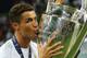 MILAN, ITALY - MAY 28: Cristiano Ronaldo of Real Madrid celebrates with the trophy following his team's victory in a penalty shootout during the UEFA Champions League final match between Real Madrid and Club Atletico de Madrid at Stadio Giuseppe Meazza on May 28, 2016 in Milan, Italy. (Photo by Matthew Ashton - AMA/Getty Images)