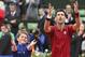 Serbia's Novak Djokovic teaches a ball boy how to celebrate a victory after winning his fourth round match of the French Open tennis tournament against Spain’s Roberto Bautista Agut at the Roland Garros stadium in Paris, France, Wednesday, June 1, 2016. (AP Photo/David Vincent)