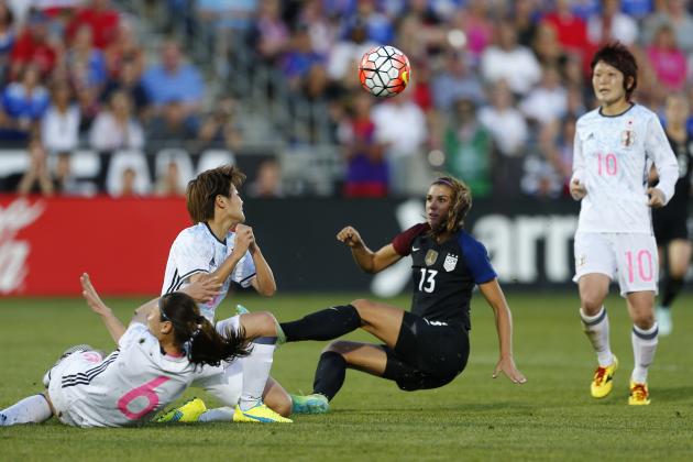 U.S. forward Alex Morgan (13) takes a shot on goal against Japan midfielder Rumi Utsugi (6)  and Tomoko Muramatsuduring an international friendly soccer match between Japan and the U.S. Thursday, June 2, 2016, in Commerce City, Colo. The match ended in a 3-3 tie. (AP Photo/Jack Dempsey)