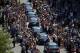Muhammad Ali's funeral procession passes as onlookers line the street Friday, June 10, 2016, in Louisville, Ky. (AP Photo/Jeff Roberson)