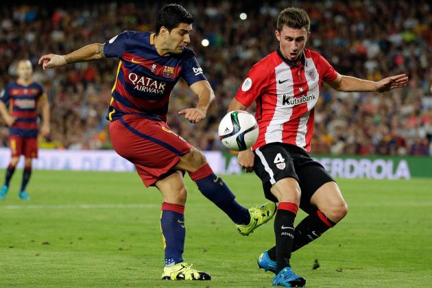 Athletic Bilbao's Aymeric Laporte, right, blocks a shot from Barcelona's Luis Suarez during a second leg Spanish Super Cup soccer match between FC Barcelona and Athletic Bilbao at the Camp Nou stadium in Barcelona, Spain, Monday, Aug.17, 2015. (AP Photo/Manu Fernandez)