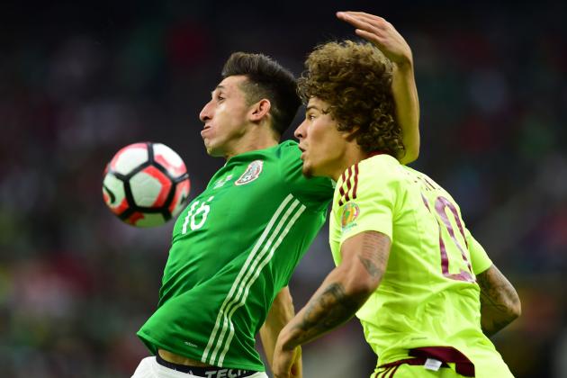 Mexico's Hector Herrera (L) and Venezuela's Rolf Feltscher vie for the ball during their Copa America Centenario football tournament match in Houston, Texas, United States, on June 13, 2016.  / AFP / ALFREDO ESTRELLA        (Photo credit should read ALFREDO ESTRELLA/AFP/Getty Images)