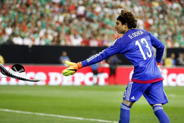 Mexico's goalie Guillermo Ochoa tosses a sombrero off the field after it was thrown from the stands by a spectator during the first half of an exhibition soccer game against Paraguay, Saturday, May 28, 2016, in Atlanta. (AP Photo/John Bazemore)