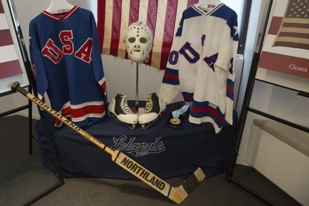 A display featuring 1980 U.S. Winter Olympics hockey goalie Jim Craig's Olympic gold medal, the jerseys, the hockey skates, and goalie equipment he wore in the Soviet and Finland games and the iconic American flag that was draped over his shoulders after the gold medal win, are displayed during a news conference, Tuesday, May 24, 2016, in New York. Craig, the hockey goaltender who helped the U.S. win a miraculous gold medal at the 1980 winter Olympics, is auctioning off the items. (AP Photo/Mary Altaffer)