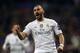 FILE - In this Tuesday, Dec. 8, 2015 file photo, Real Madrid's Karim Benzema celebrates scoring the opening goal during a Champions League group A soccer match between Real Madrid and Malmo at the Santiago Bernabeu stadium in Madrid. French Football Federation president Noel Le Graet on Wednesday, June 22, 2016 has opened the door for striker Karim Benzema's return after the European Championship. The Real Madrid forward is facing preliminary charges of conspiracy to blackmail in a sex-tape scandal involving France teammate Mathieu Valbuena. (AP Photo/Daniel Ochoa de Olza, file)