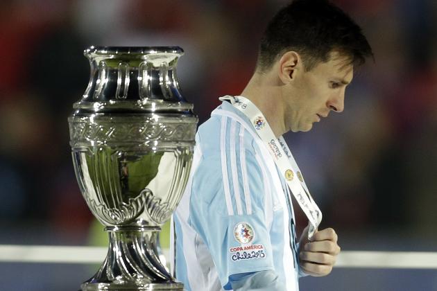 FILE - In this July 4, 2015, file photo, Argentina's Lionel Messi walks by the Copa America trophy after receiving the silver medal after the final game with Chile at the National Stadium in Santiago, Chile. Chile goalkeeper Claudio Bravo made a save and striker Alexis Sanchez converted the winning penalty as host Chile defeated Argentina 4-1 in a shootout after a 0-0 draw in the Copa America final.(AP Photo/Natacha Pisarenko, File)