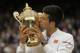 Novak Djokovic kisses the trophy after his victory over Roger Federer in the mens singles final on Centre Court during day thirteen of Wimbledon 2015 at the All England Lawn Tennis Club on July 12th 2015 in Wimbledon (Photo by Tom Jenkins/Getty Images)