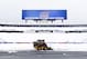 Workers clear snow from the field at Ralph Wilson Stadium on Sunday, Nov. 23, 2014, in Orchard Park, N.Y. Snowed out today at the stadium, the Bills are in Detroit to play their