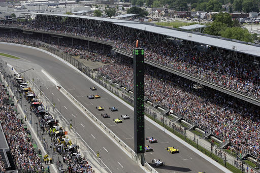 The field heads into the first turn on the start of the 100th running of the Indianapolis 500 auto race at Indianapolis Motor Speedway in Indianapolis, Sunday, May 29, 2016. (AP Photo/Michael Conroy)