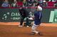 Britain's Kyle Edmund, front, drops to his knees in celebration after having won his Davis Cup quarterfinal tennis match against Serbia's Dusan Lajovic in Belgrade, Serbia, Sunday, July 17, 2016. Britain advanced to the Davis Cup semifinals after having defeated Serbia in Belgrade. (AP Photo/Marko Drobnjakovic)