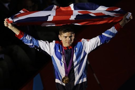 Gold medalist Luke Campbell of Great Britain, carries his country's flag after the medals ceremony for bantamweight 56-kg boxing at the 2012 Summer Olympics, Saturday, Aug. 11, 2012, in London. (AP Photo/Patrick Semansky)