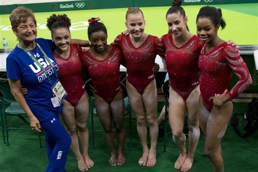 The United States women's gymnastic team poses for a picture with head coach Martha Karolyi, left, after finishing podium training ahead of the 2016 Summer Olympics in Rio de Janeiro, Brazil, Thursday, Aug. 4, 2016. From right, are gymnasts Gabby Douglas, Alexandra Raisman, Madison Kocian, Simone Biles, and Lauren Hernandez.(AP Photo/Rebecca Blackwell)
