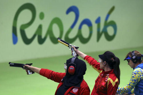 Athletes compete during the women's 10-meter air pistol qualification at Olympic Shooting Center at the 2016 Summer Olympics in Rio de Janeiro, Brazil, Sunday, Aug. 7, 2016. (AP Photo/Eugene Hoshiko)
