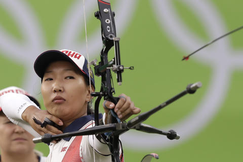 Russia's Inna Stepanova releases her arrow during the women's team archery competition at the Sambadrome venue during the 2016 Summer Olympics in Rio de Janeiro, Brazil, Sunday, Aug. 7, 2016. (AP Photo/Natacha Pisarenko)