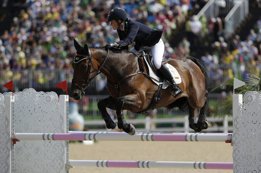 Camilla Kruger, of Zimbabwe, riding Biarritz, competes in the equestrian eventing show jumping phase at the 2016 Summer Olympics in Rio de Janeiro, Brazil, Tuesday, Aug. 9, 2016. (AP Photo/John Locher)