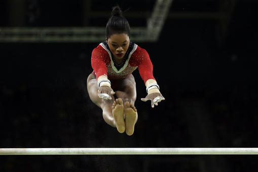 United States' Gabrielle Douglas performs on the uneven bars during the artistic gymnastics women's apparatus final at the 2016 Summer Olympics in Rio de Janeiro, Brazil, Sunday, Aug. 14, 2016. (AP Photo/Dmitri Lovetsky)