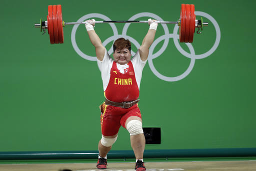 Meng Suping, of China, executes a successful lift in her final attempt in the clean and jerk competition to win the gold medal in the women's 75kg weightlifting event at the 2016 Summer Olympics in Rio de Janeiro, Brazil, Sunday, Aug. 14, 2016. (AP Photo/Mike Groll)
