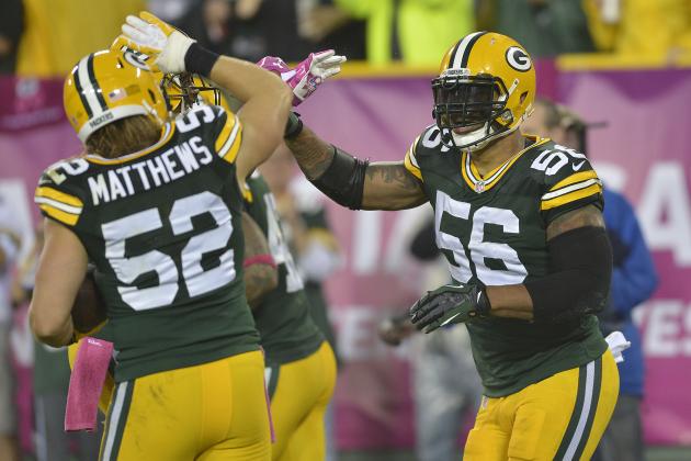 GREEN BAY - OCTOBER 02: Julius Peppers #56 of the Green Bay Packers celebrates a touchdown with Clay Matthews #52 following an interception during an NFL game against the Minnesota Vikings at Lambeau Field, October 2, 2014 in Green Bay Wisconsin.  (Photo by Tom Dahlin/Getty Images)