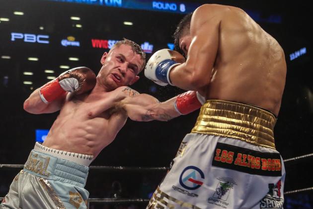 NEW YORK, NY - JULY 30: Leo Santa Cruz of Mexico (gold trunks) fights Carl Frampton of Northern Ireland (blue trunks) during their 12 round WBA Super featherweight championship bout at Barclays Center on July 30, 2016 in the Brooklyn borough in New York City. (Photo by Anthony Geathers/Getty Images)